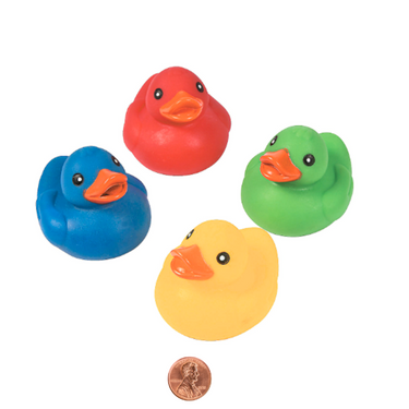Four colorful floating rubber ducks (red, blue, yellow, green) with a penny for scale on a white background.